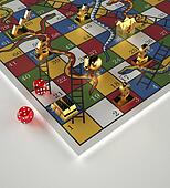 Tokens and dice on Snakes and Ladders game Tokens and dice on Snakes and Ladders game